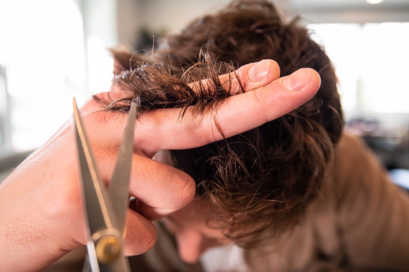 A hairdresser cutting hair in a salon